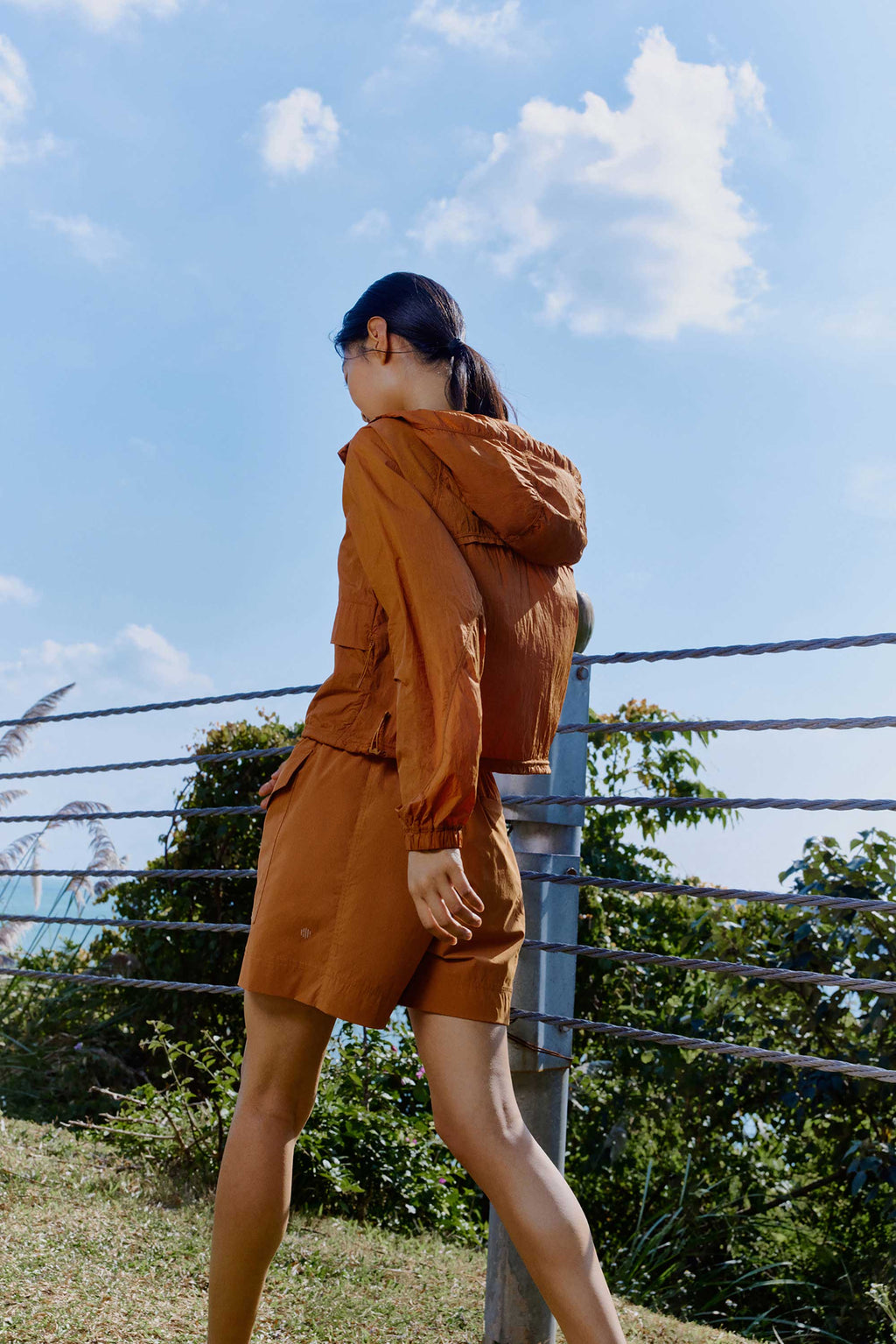woman in brown jacket and shorts