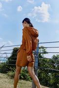 woman in brown jacket and shorts