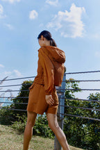 woman in brown jacket and shorts
