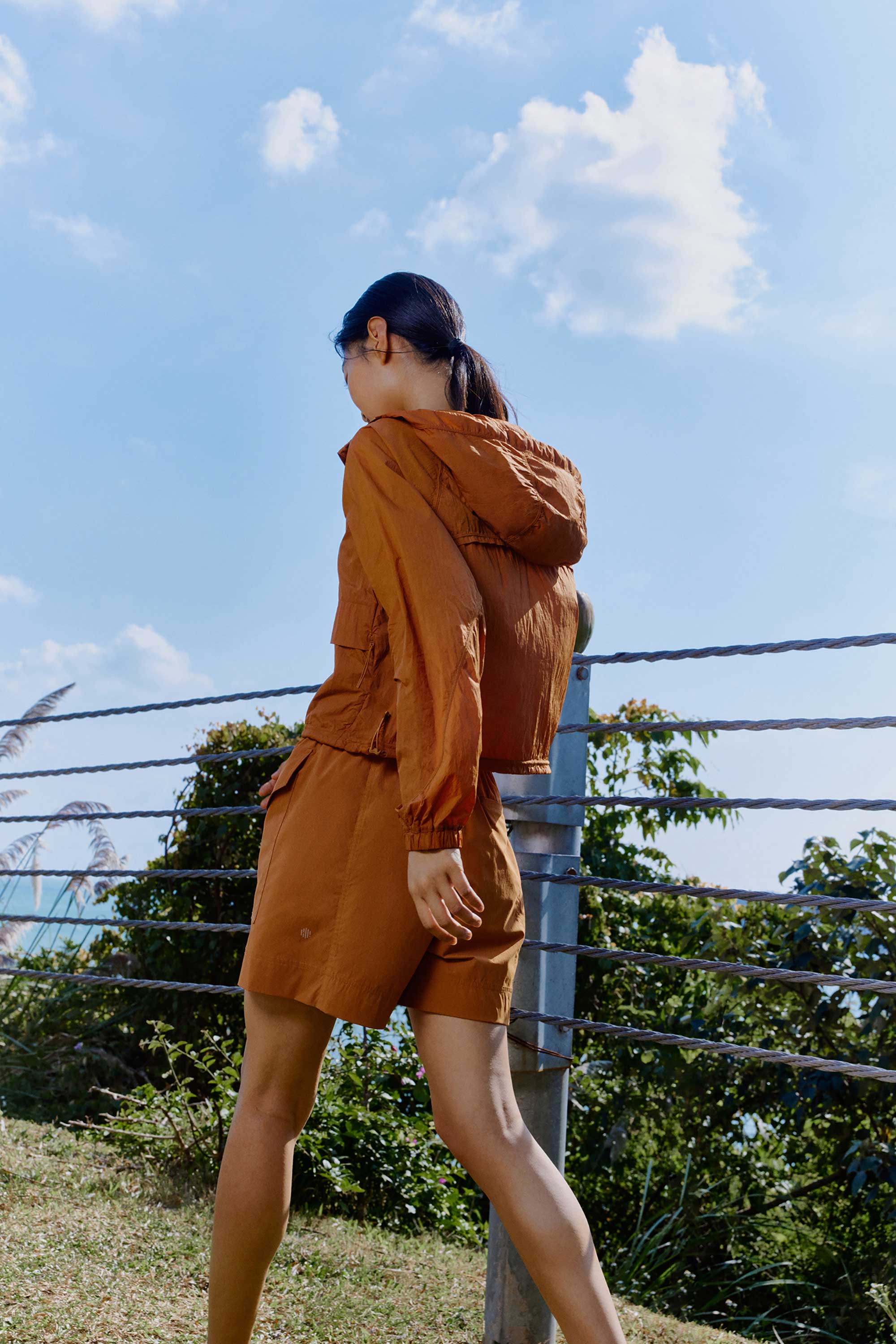 woman in brown jacket and shorts
