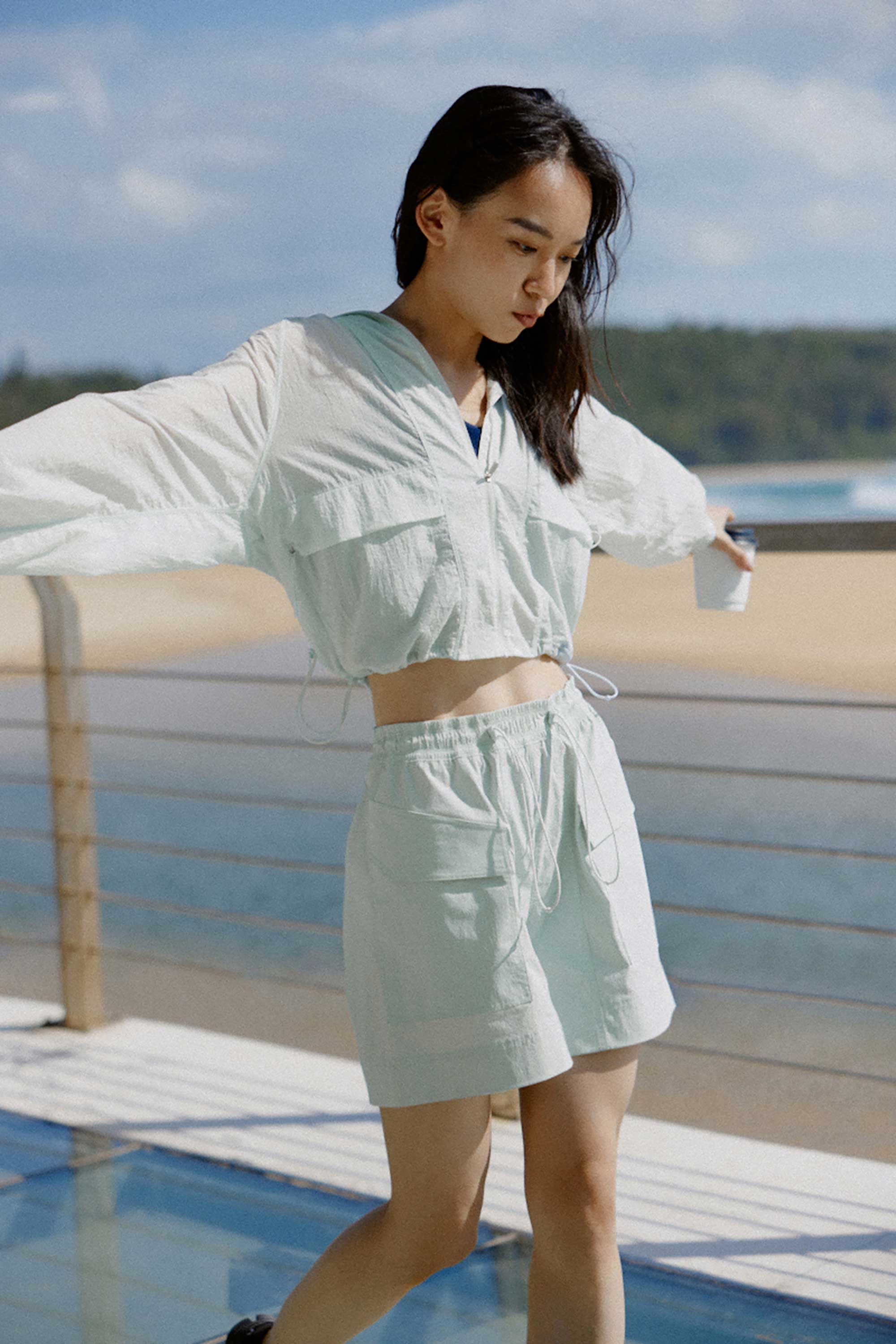 woman in blue jacket and shorts