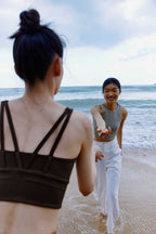 woman in blue pants and grey tank
