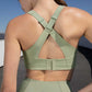 back of woman in green sports bra and leggings