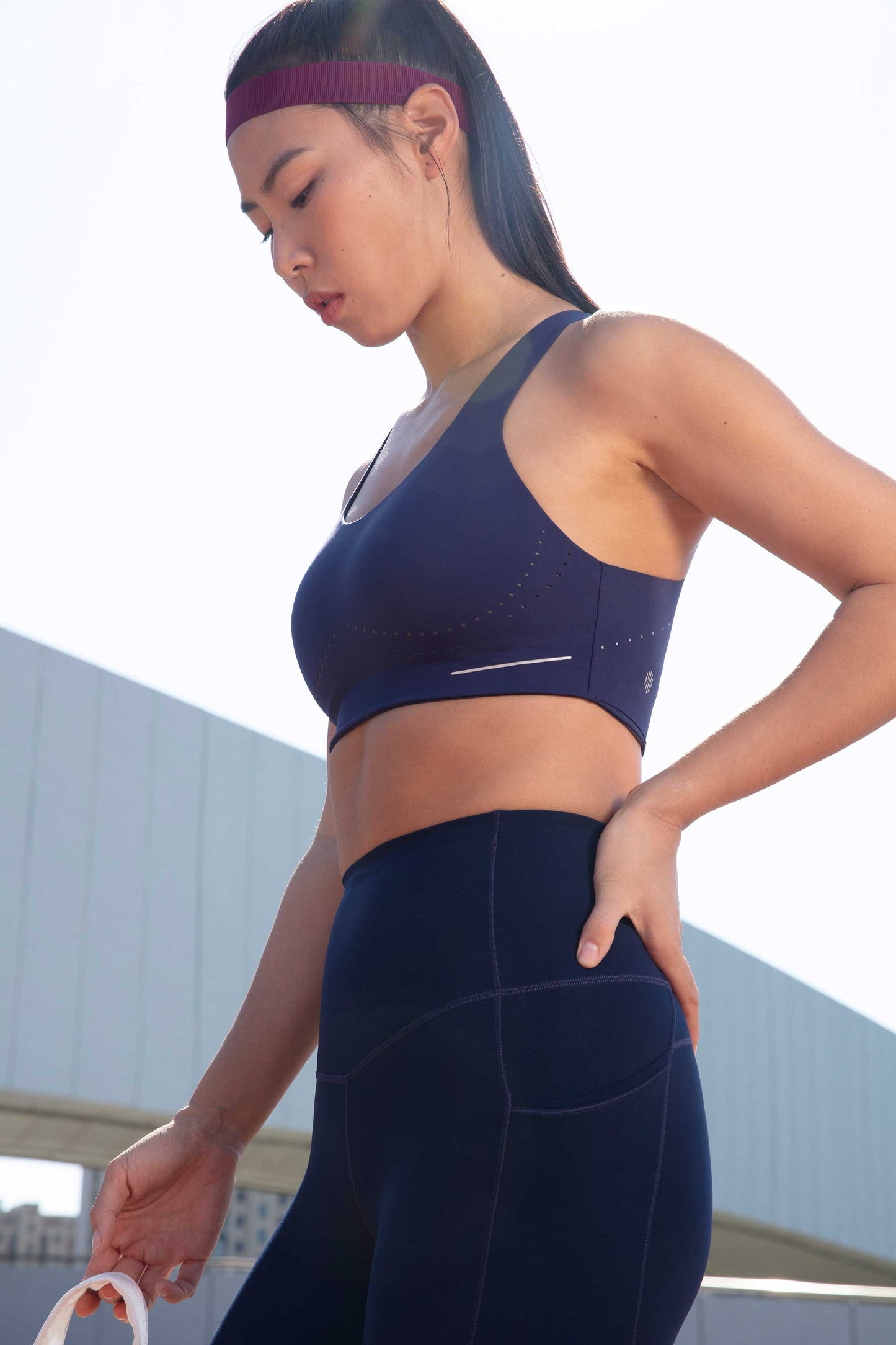side of woman in blue sports bra and leggings