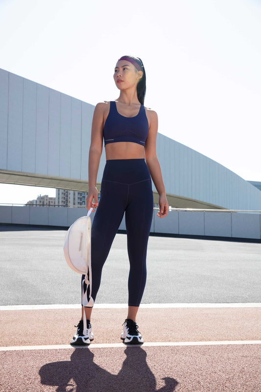 woman in navy sports bra and leggings