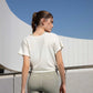 back of woman in white t-shirt and green leggings