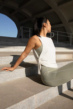 woman with pink tank top and green leggings