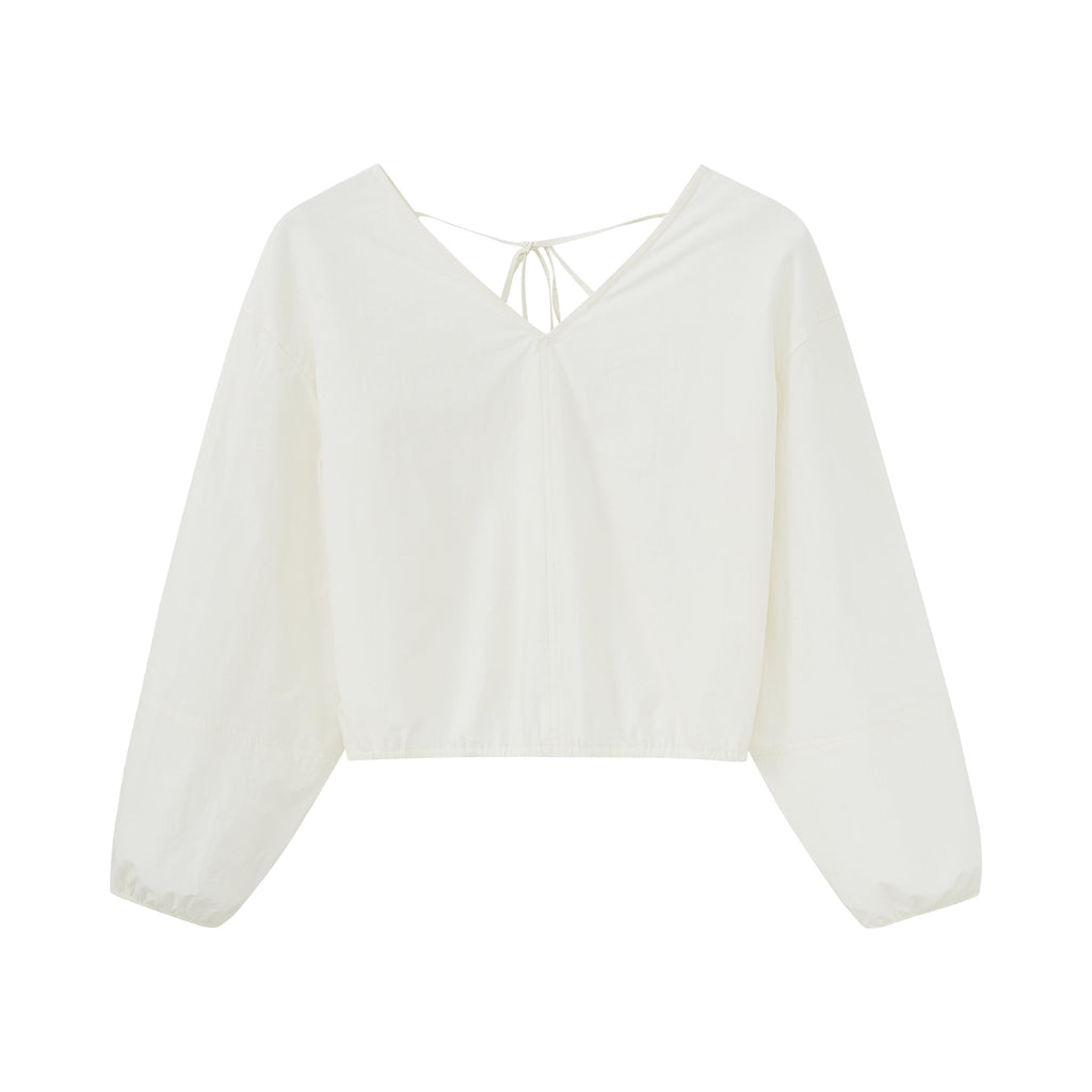 Flat lay of white top.