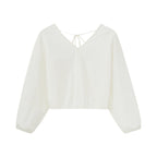 Flat lay of white top.