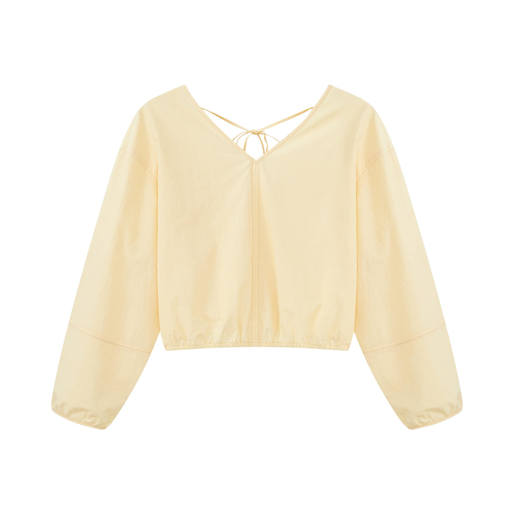 Flat lay of yellow top.