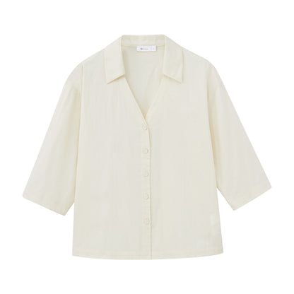 Flat lay of ivory top.