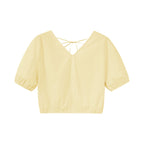 Flat lay of yellow top.