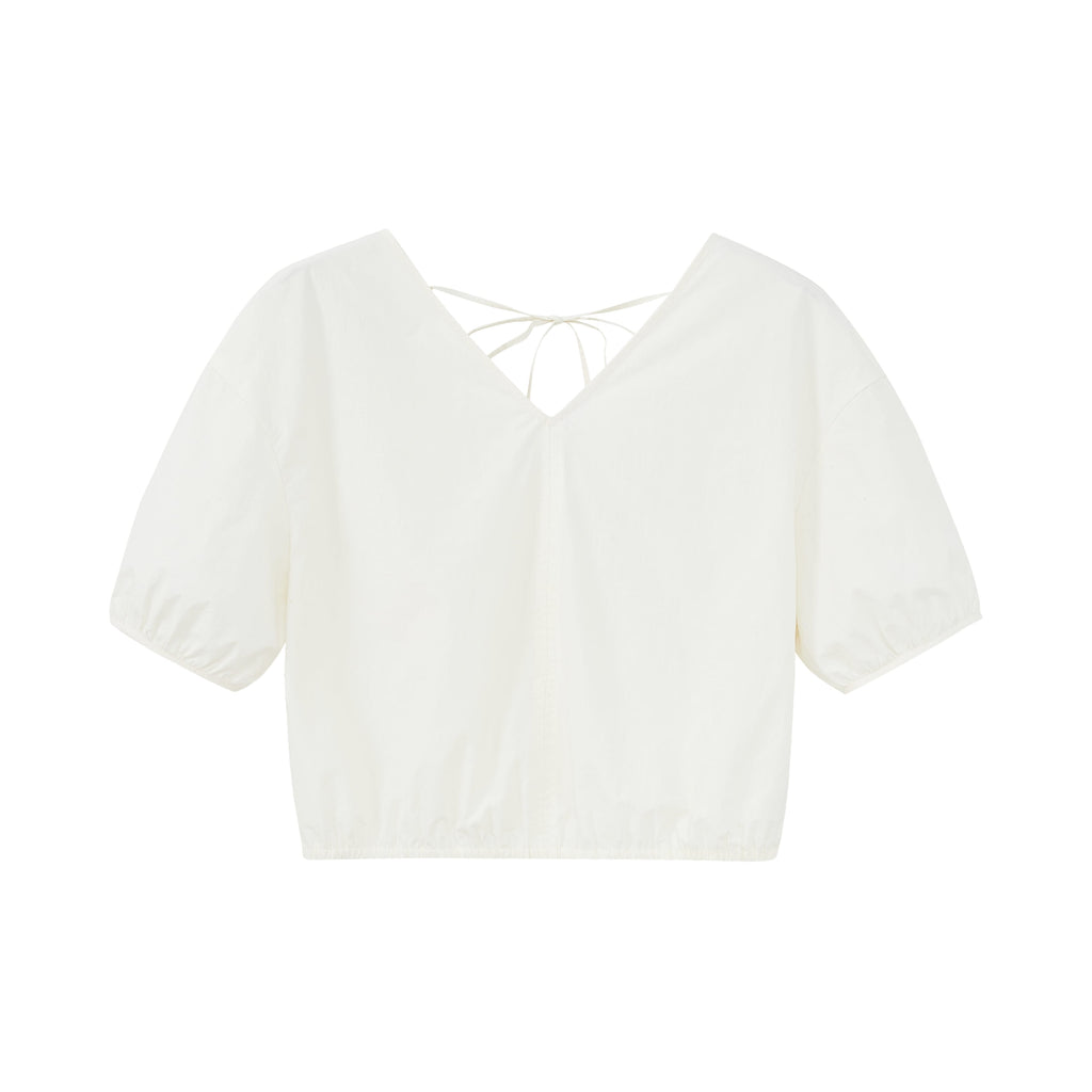 Flat lay of white top.