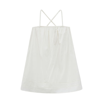 Flat lay of cream-colored pajama dress.