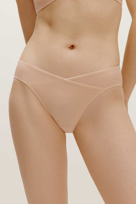 a woman wearing a nude Crossover Low Waist Brief
