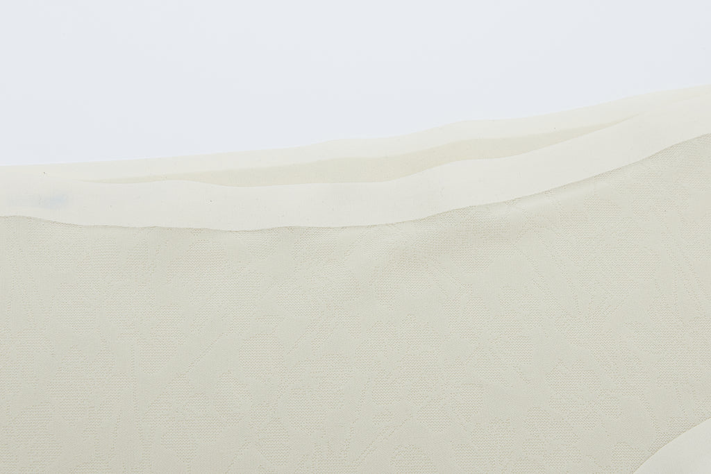 Close-up of off-white lace fabric