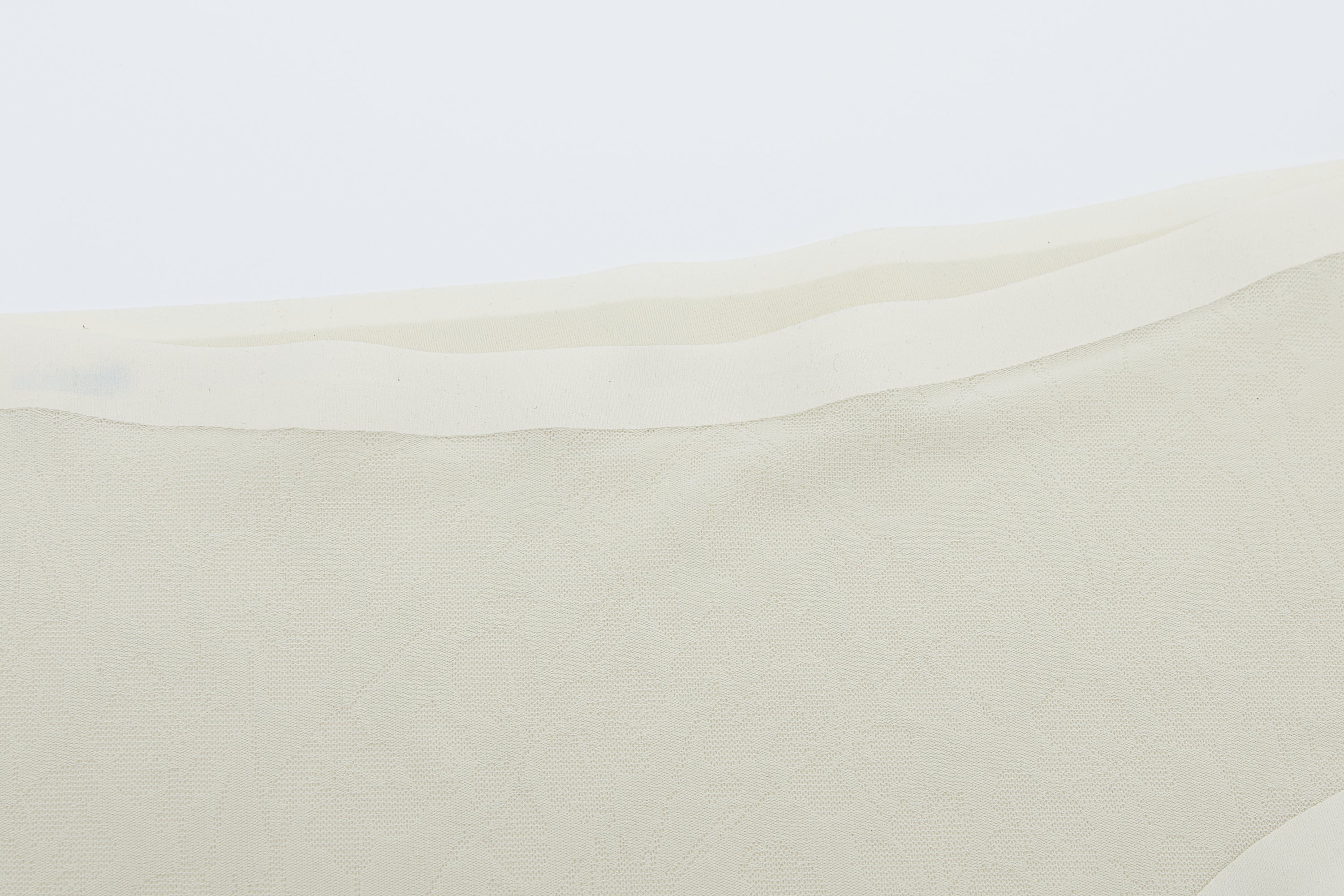 Close-up of off-white lace fabric
