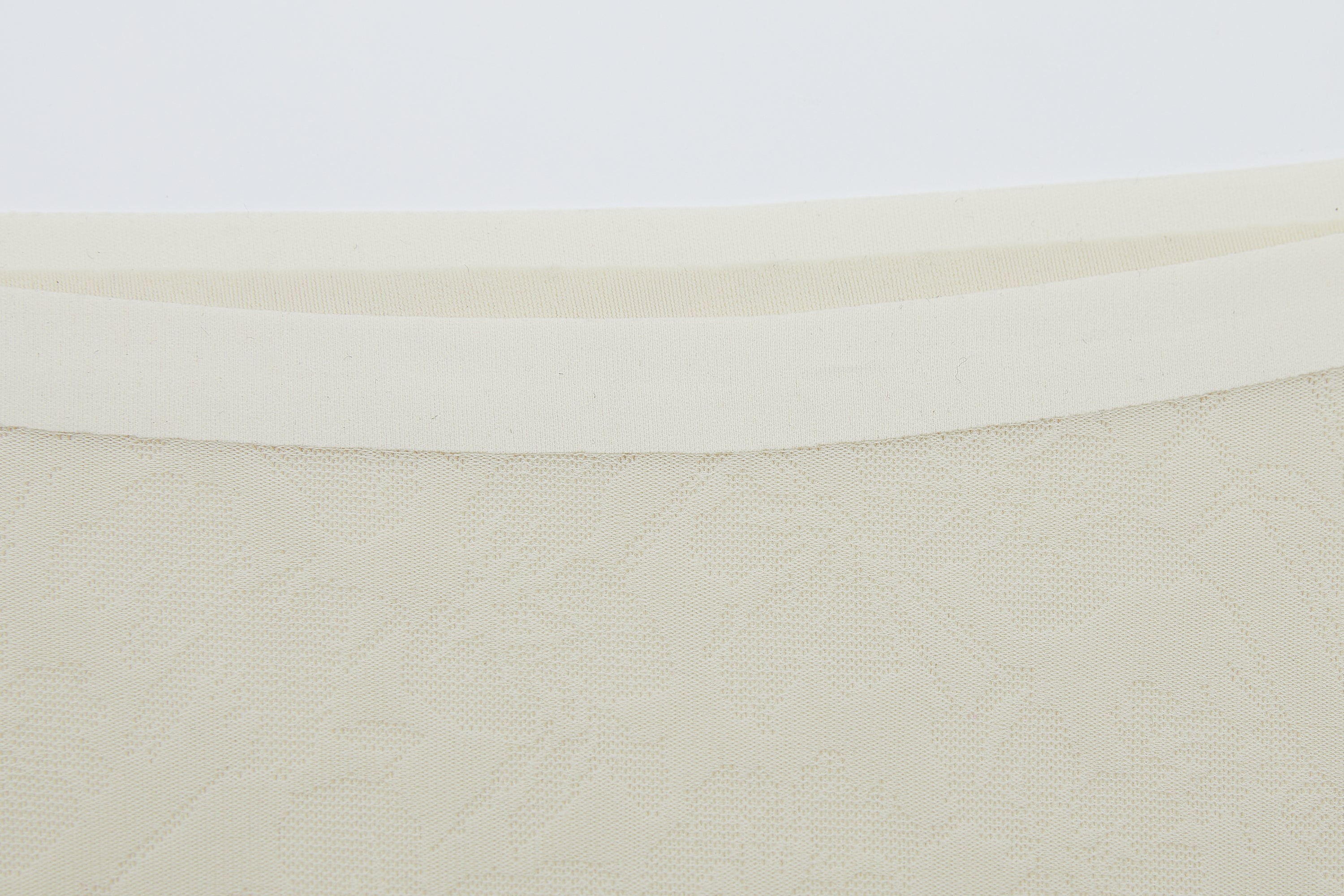 Close-up of off-white lace fabric