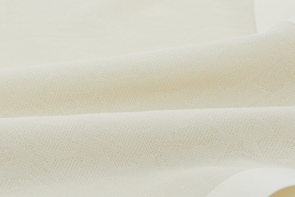 Close-up of off-white lace fabric