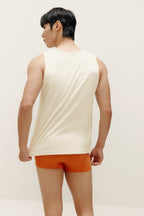 back side of man wearing white tank top and orange briefs