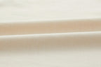 Closeup of beige fabric. White color.