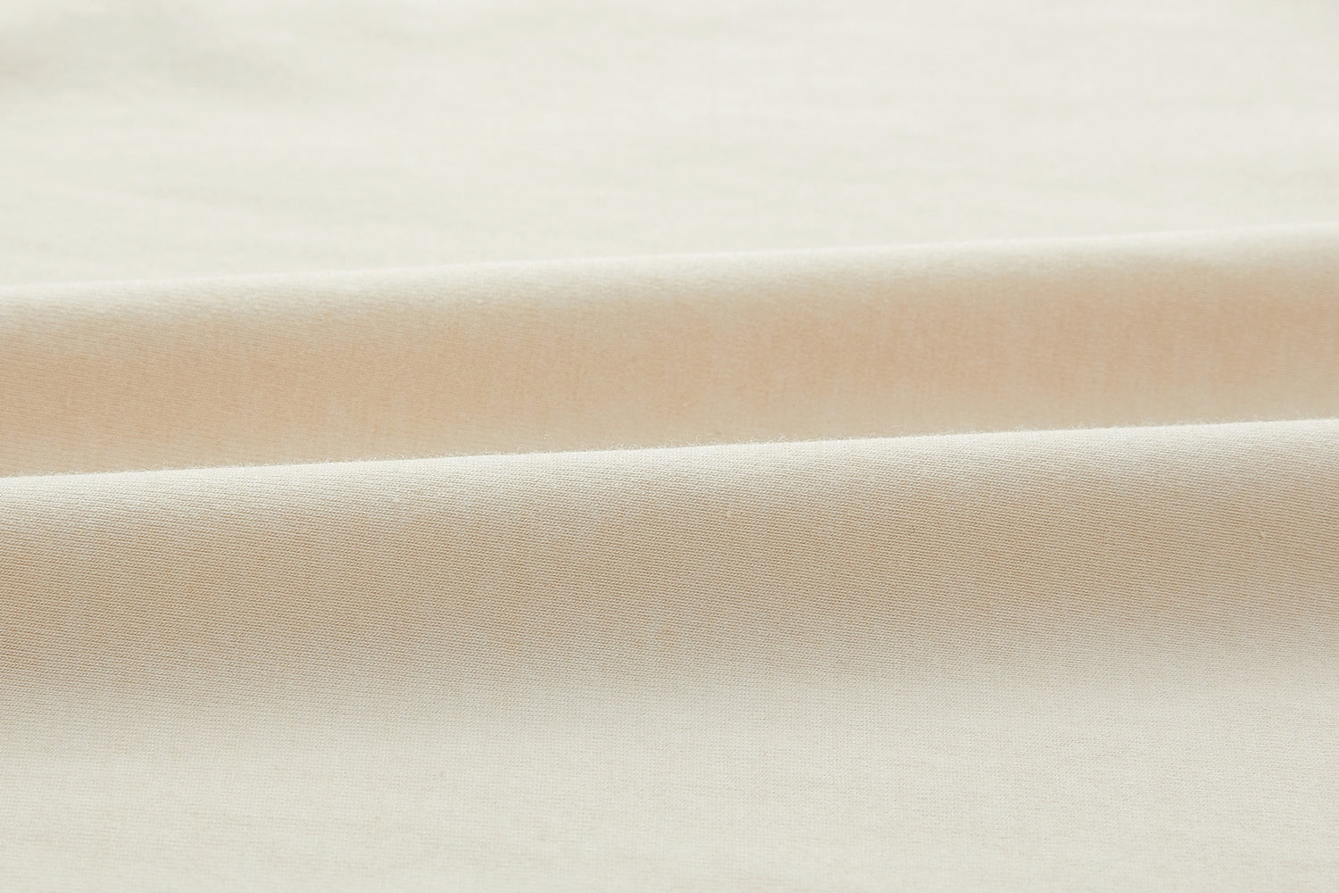 Closeup of beige fabric. White color.
