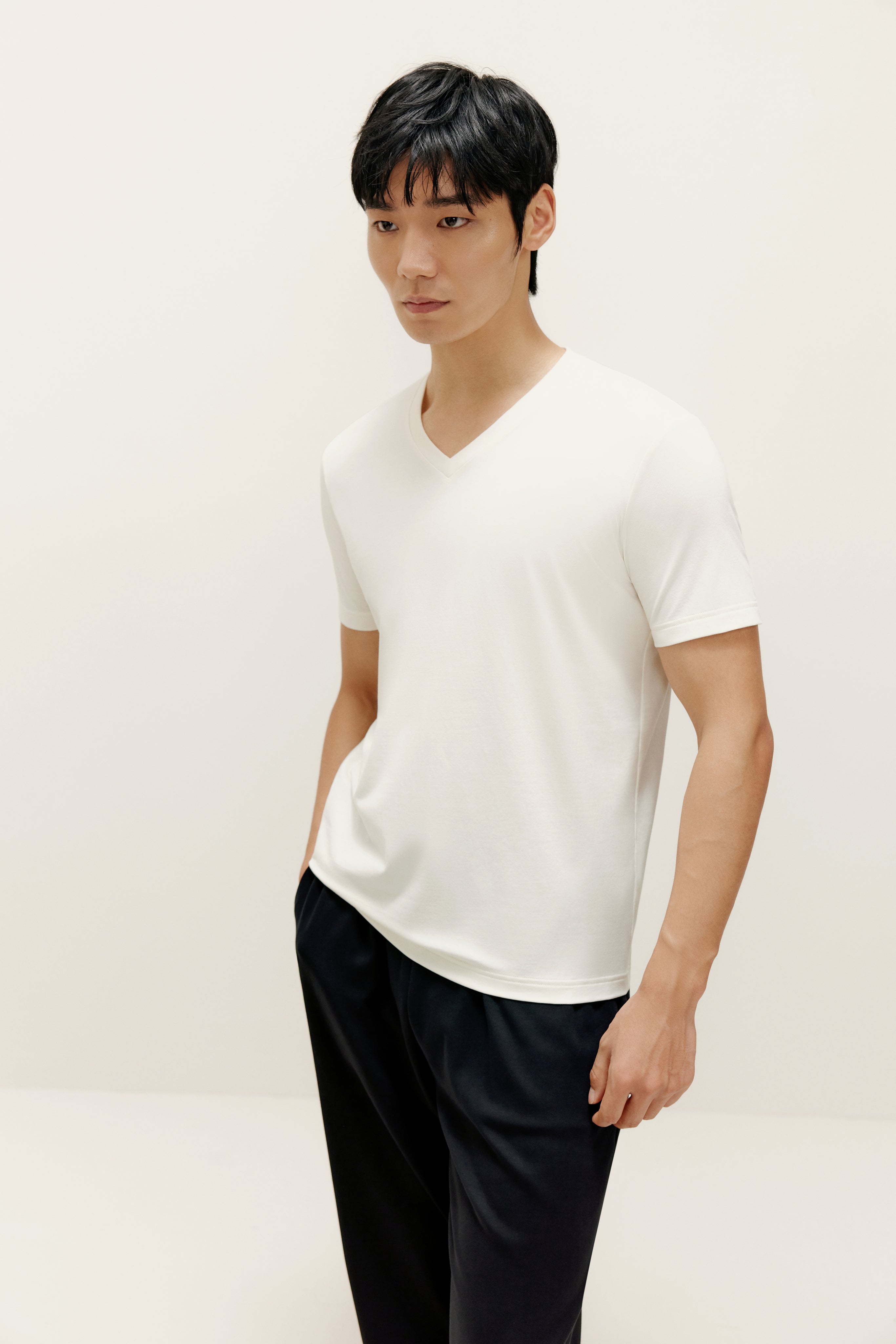 Man wearing white V-neck T-shirt and black lounge pants