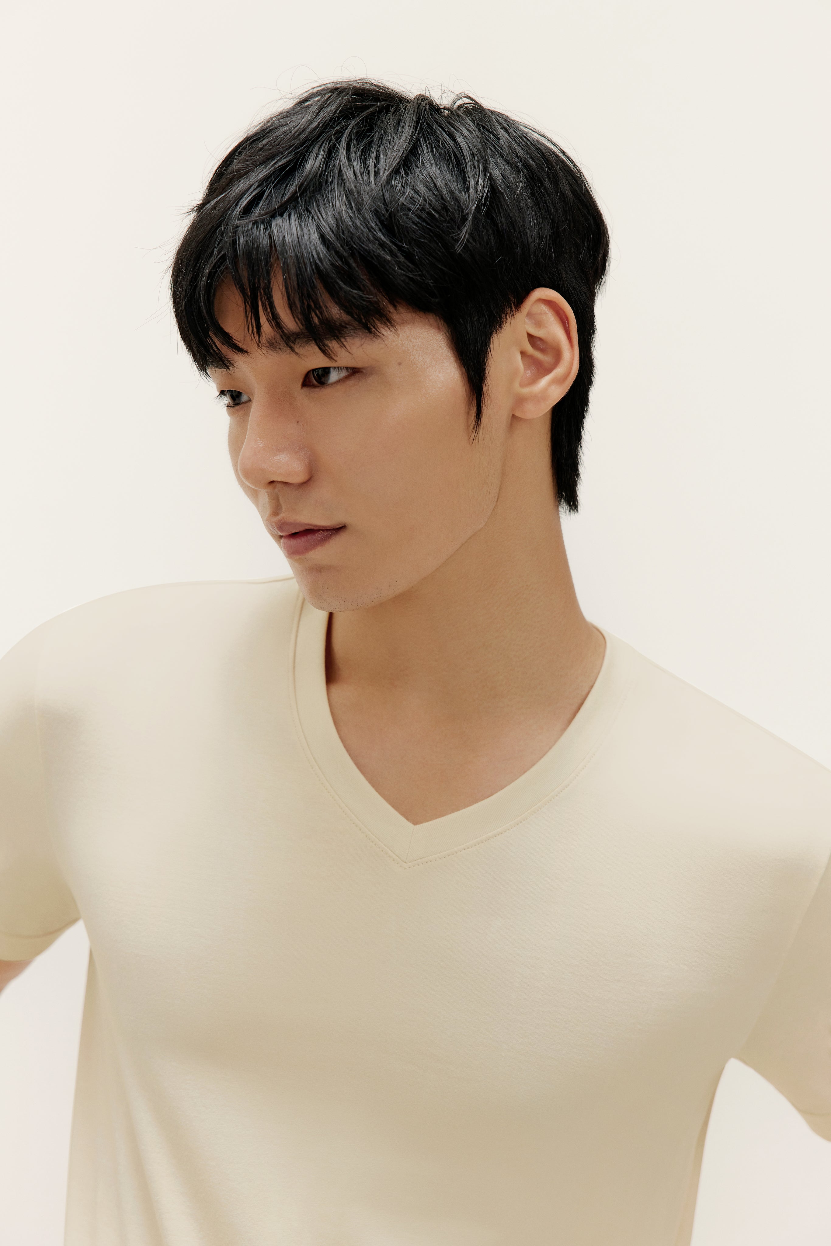 Man wearing beige V-neck T-shirt