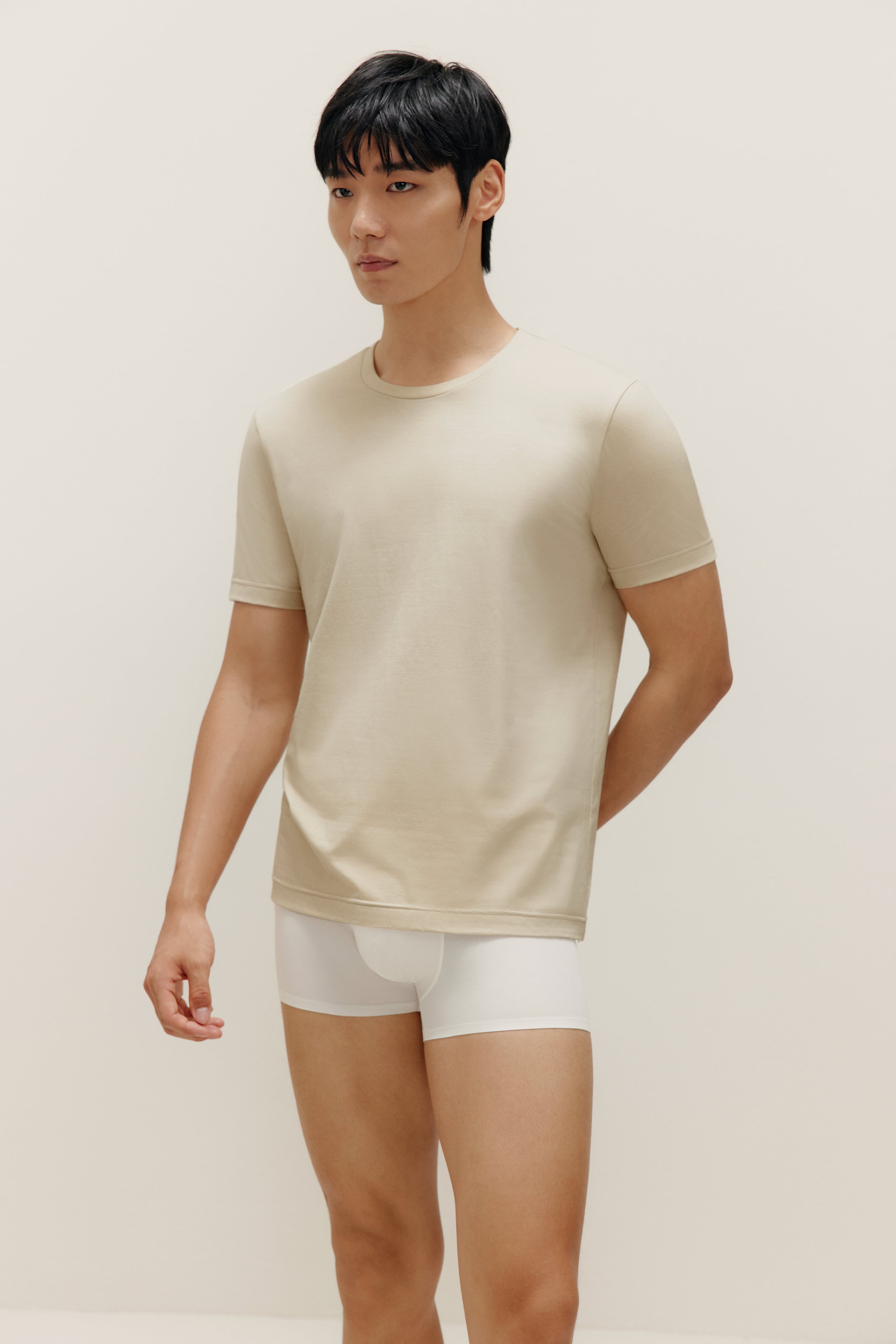 Man wearing beige T-shirt and white boxer briefs