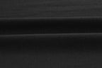 Closeup of black fabric. Black color.