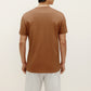 back of a man wearing brown t shirt and white shorts