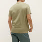 back of a man wearing green t shirt and dark green shorts