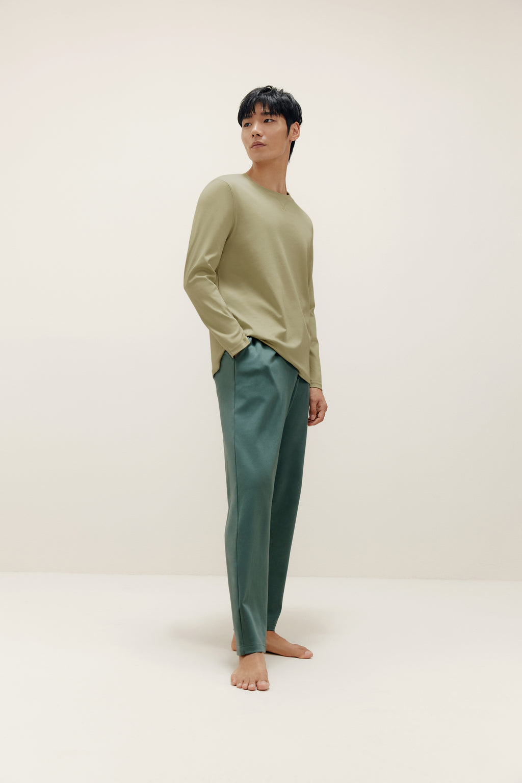man wearing a green long sleeve and dark green pants