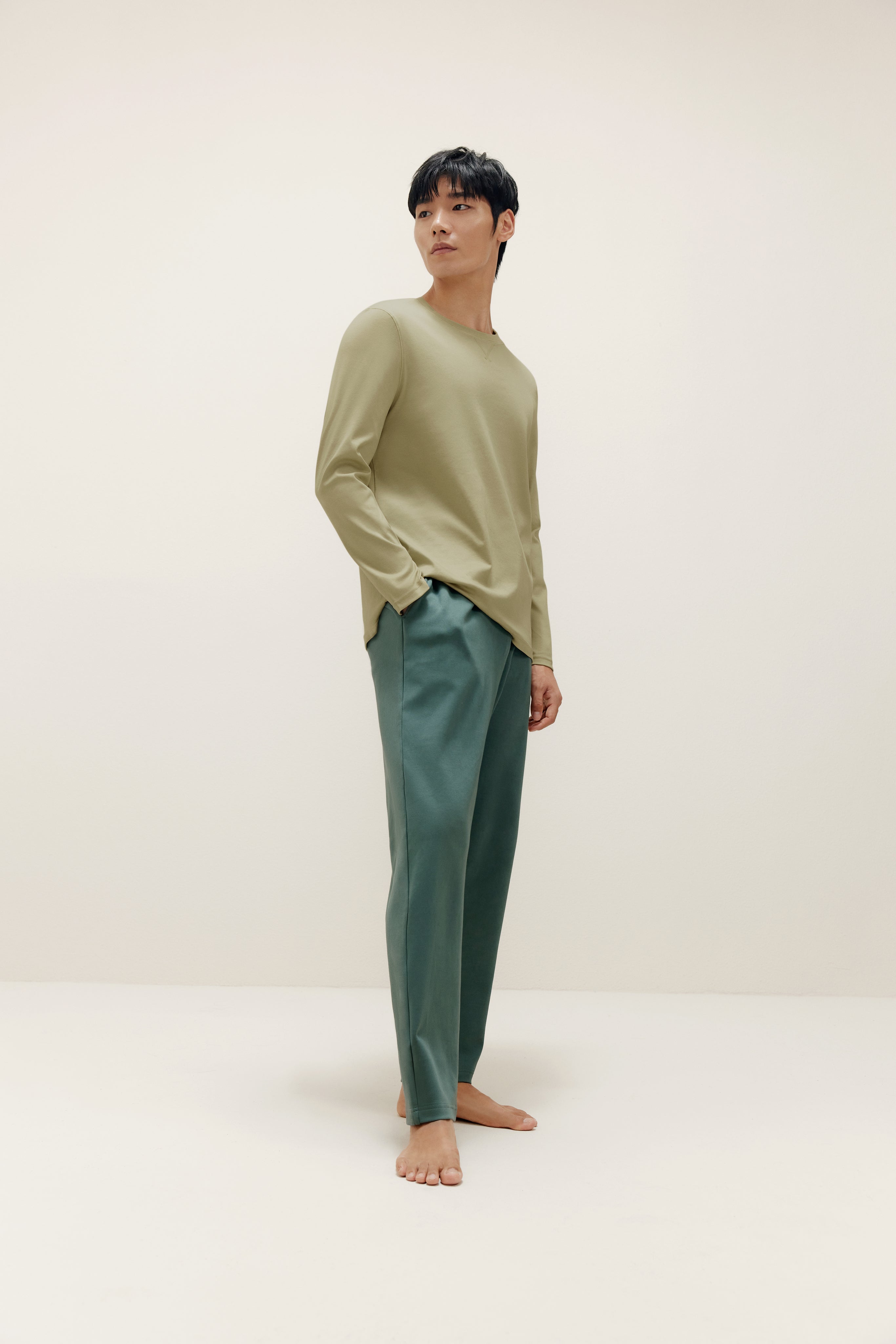 man wearing a green long sleeve and dark green pants