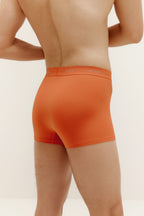 A man wearing orange brief. Sienna color.