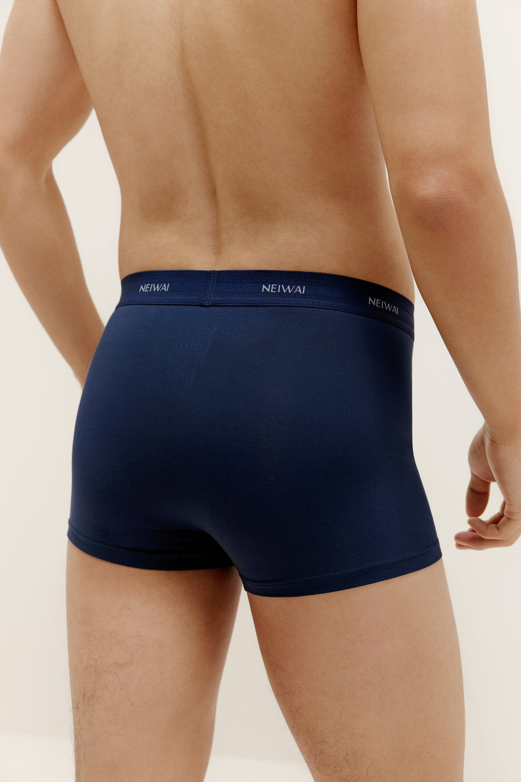 A man wearing navy brief from back. Navy color.