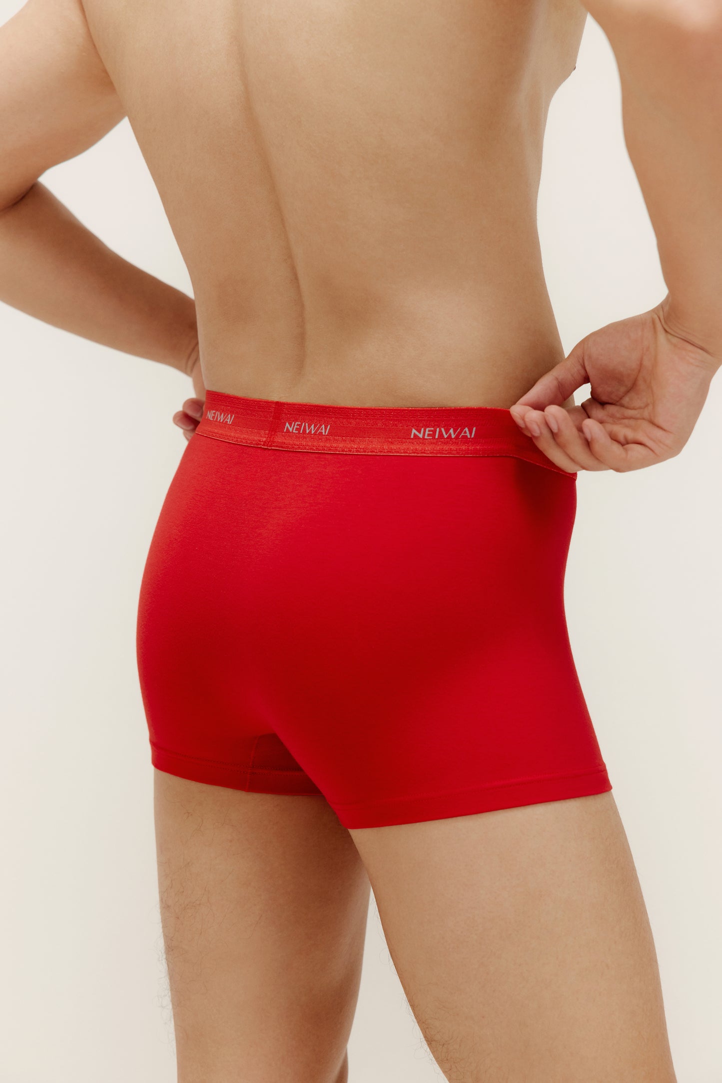 a man wearing a red brief from back view
