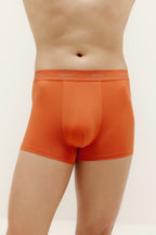 A man wearing orange brief. Sienna color.