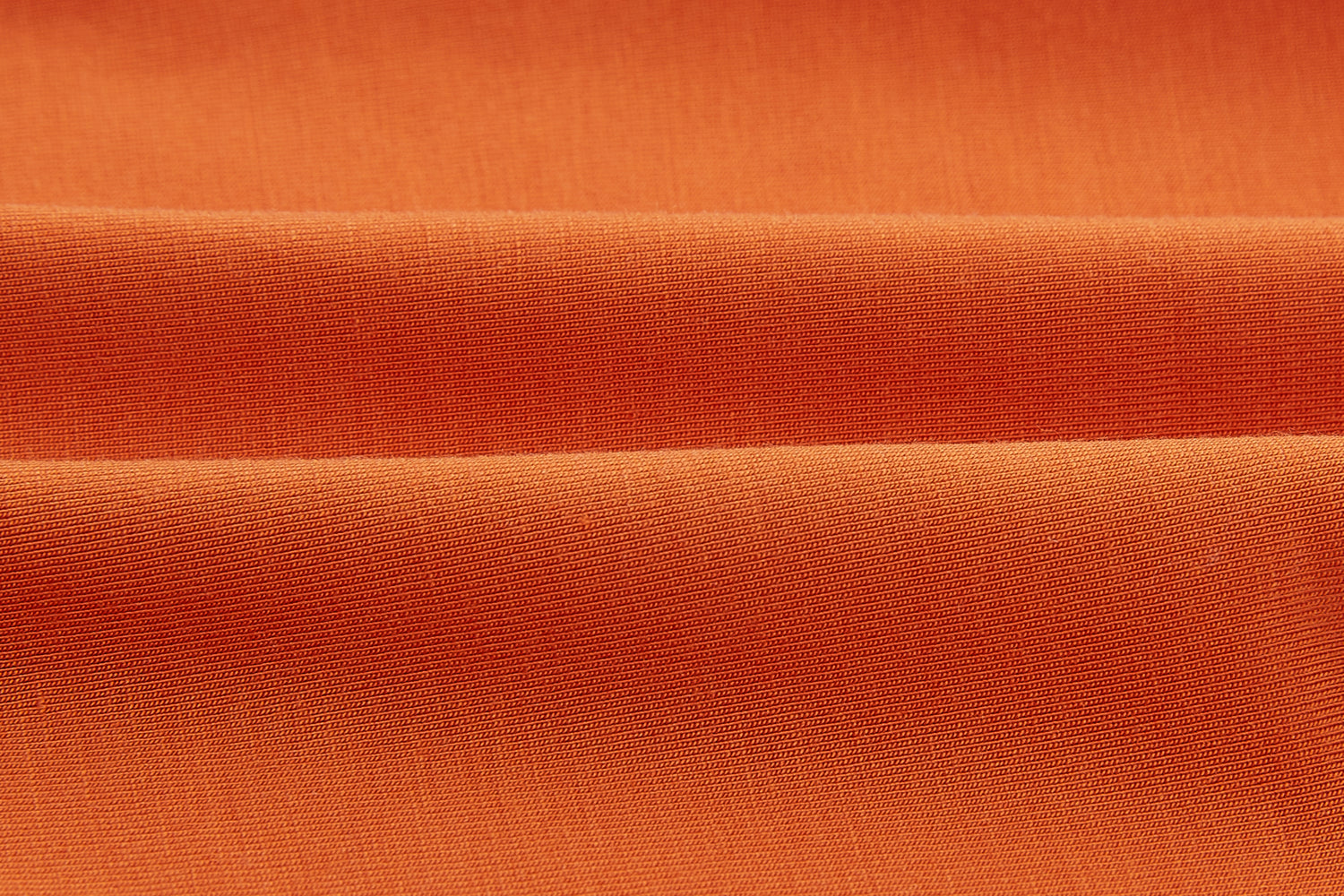 close up of the modal fabric in orange color. Sienna color. 