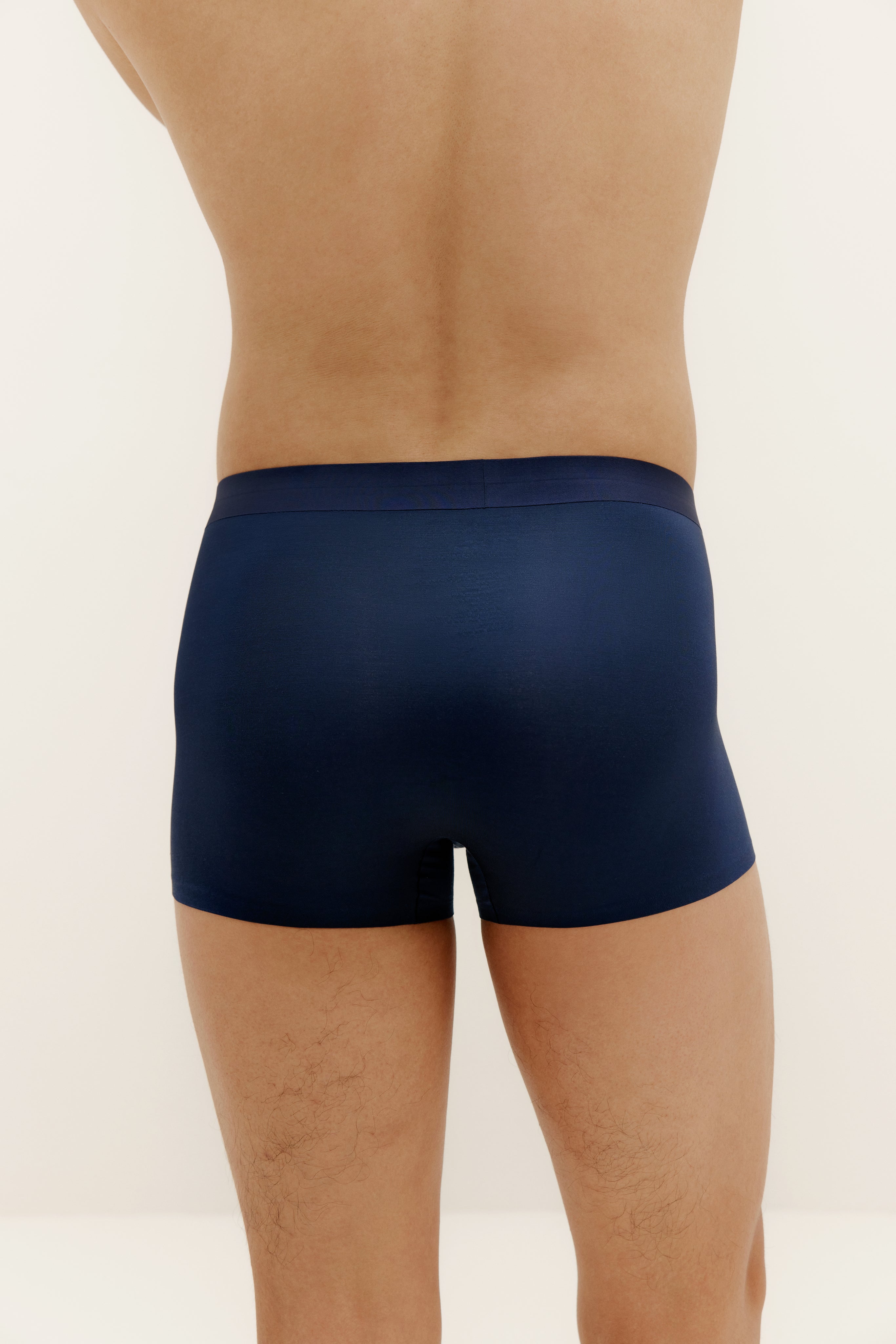 back of man in navy brief