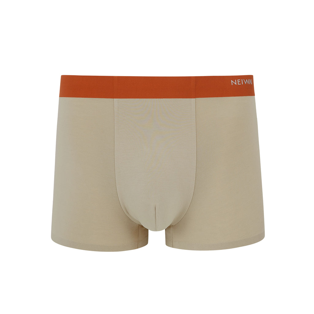 Flat lay of tan boxer briefs with orange waistband. Oatmeal color. 
