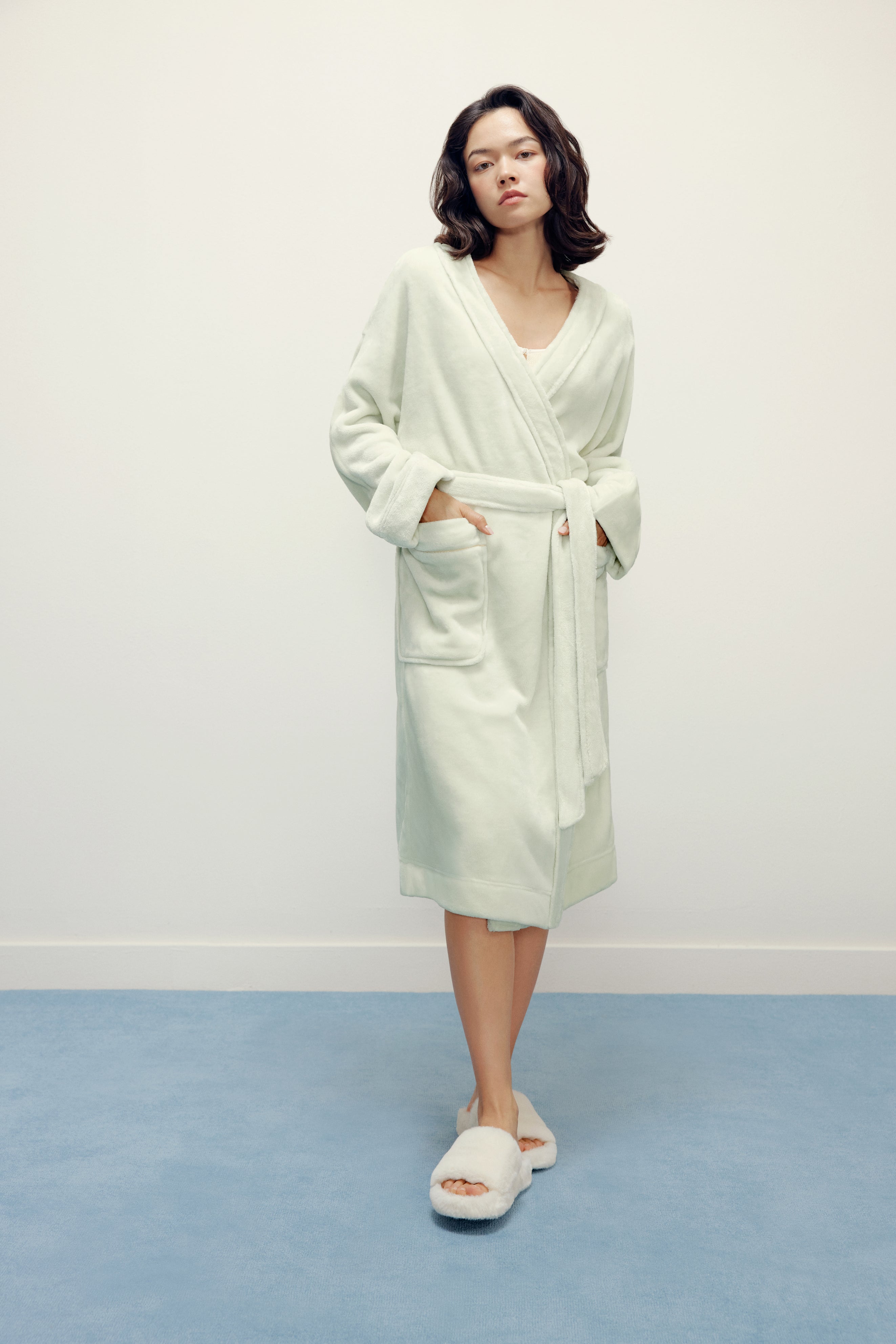woman wearing a light green fleece robe