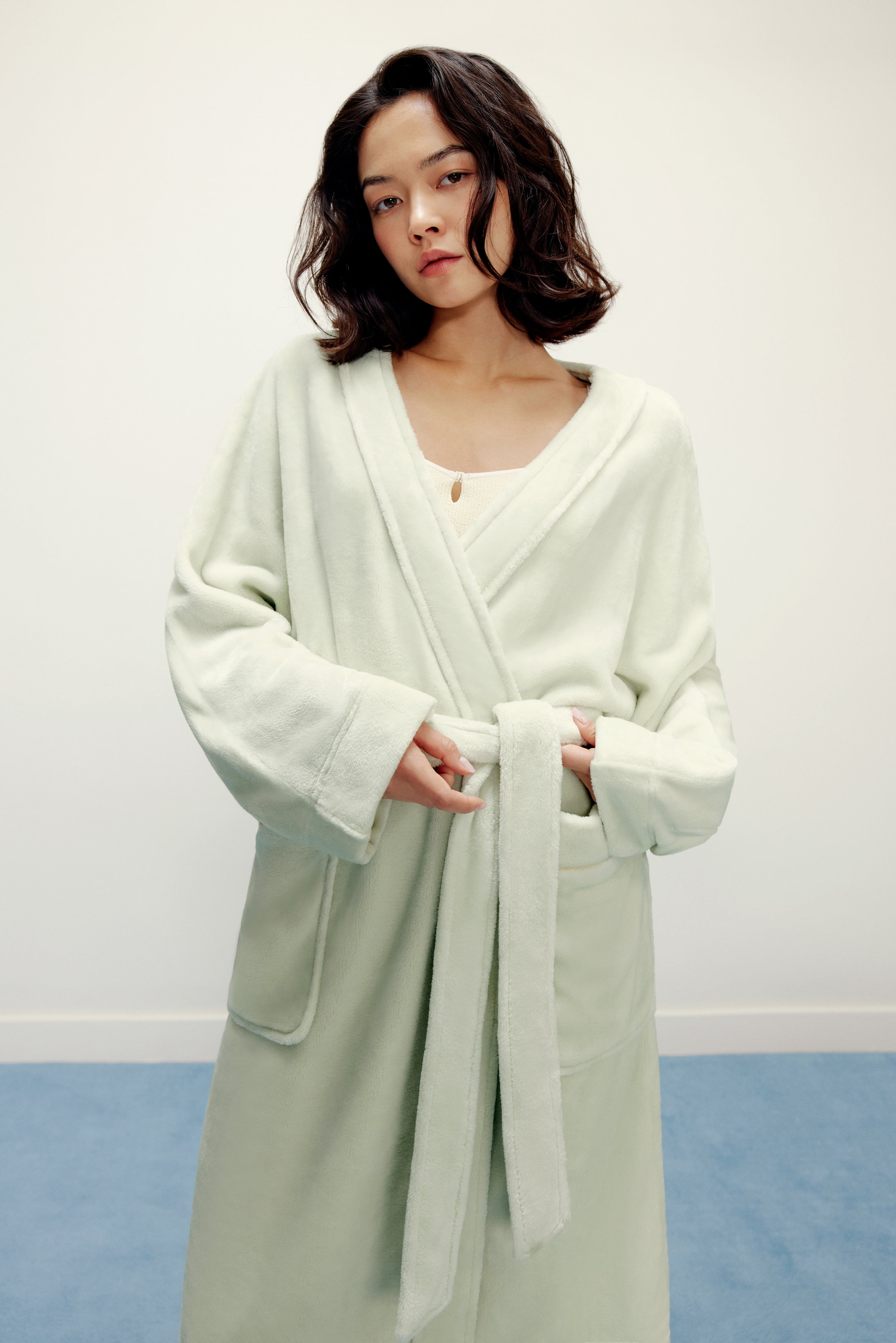  woman wearing a light green fleece robe