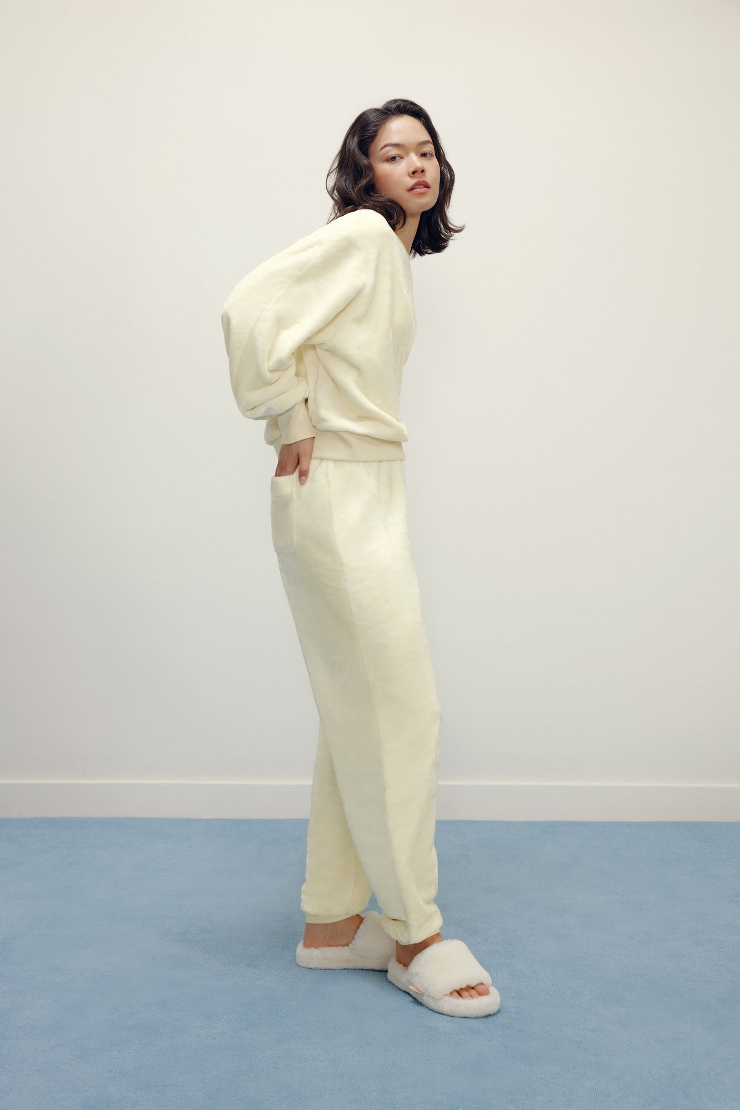 woman in cream fleece pajama set