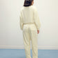 back of woman in cream fleece pajama set