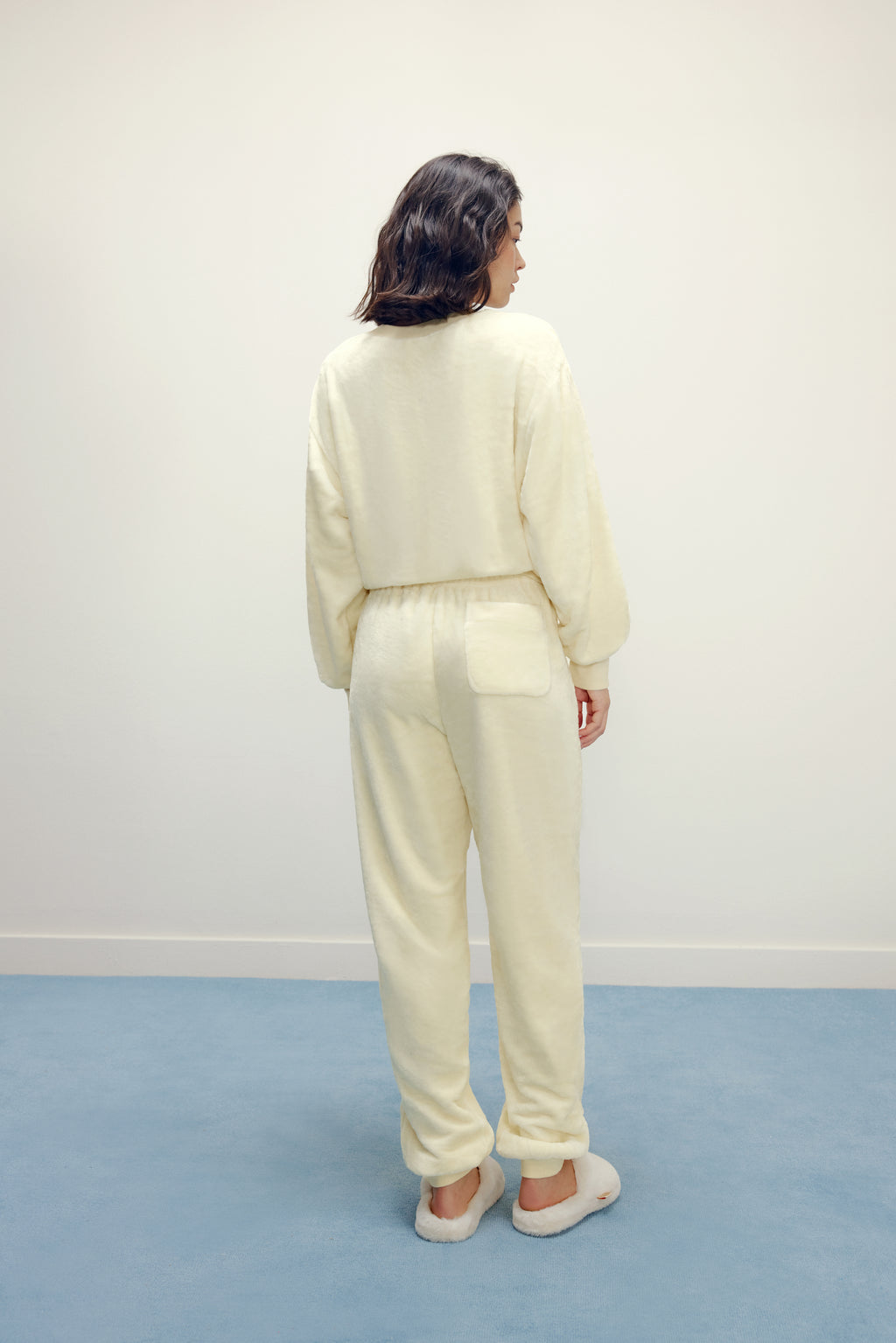 Women from back with cream color fluffy loungewear set