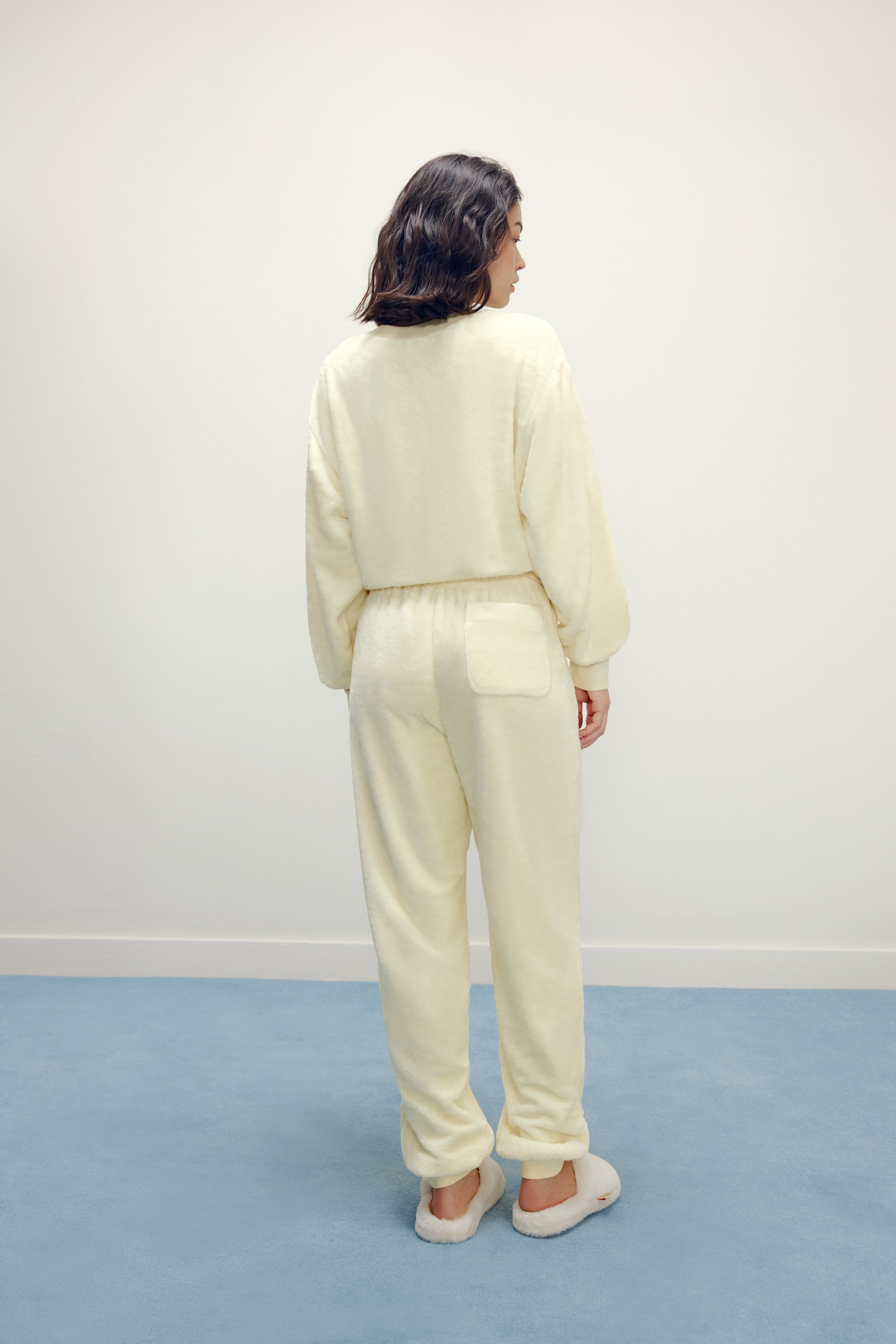 Women from back with cream color fluffy loungewear set