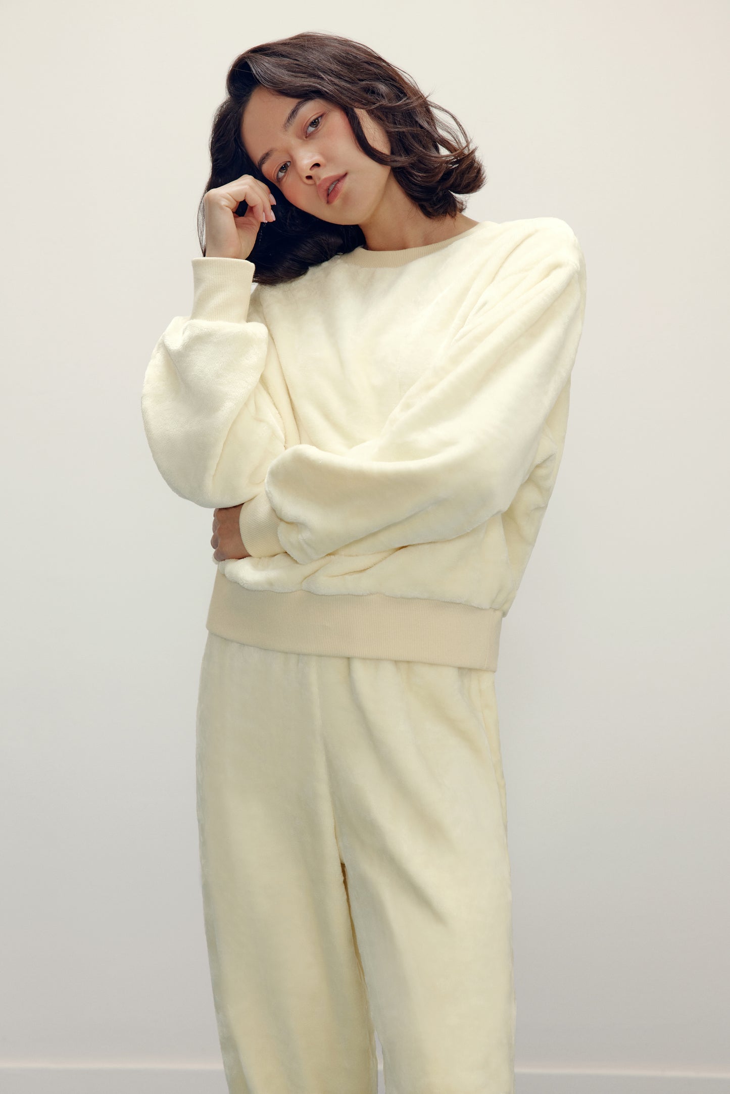 woman in cream fleece pajama set