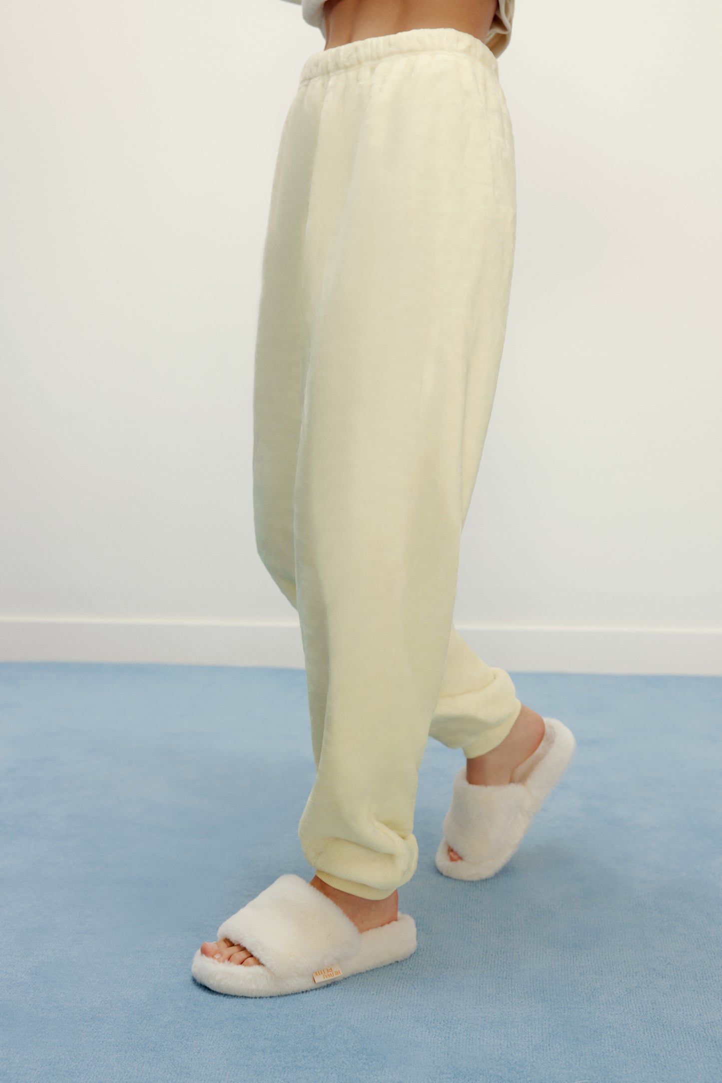Women Legs with cream color fluffy lounge pants