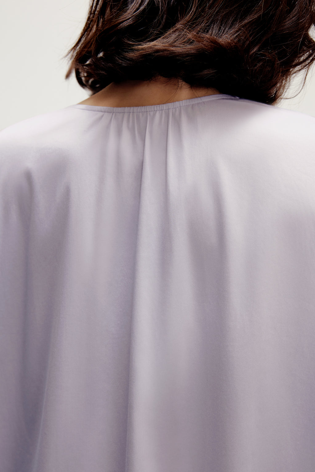 back of a woman wearing a purple pajama top